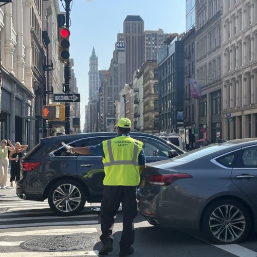 Pedestrian Traffic Managers at the intersection of Broome Street and Broadway