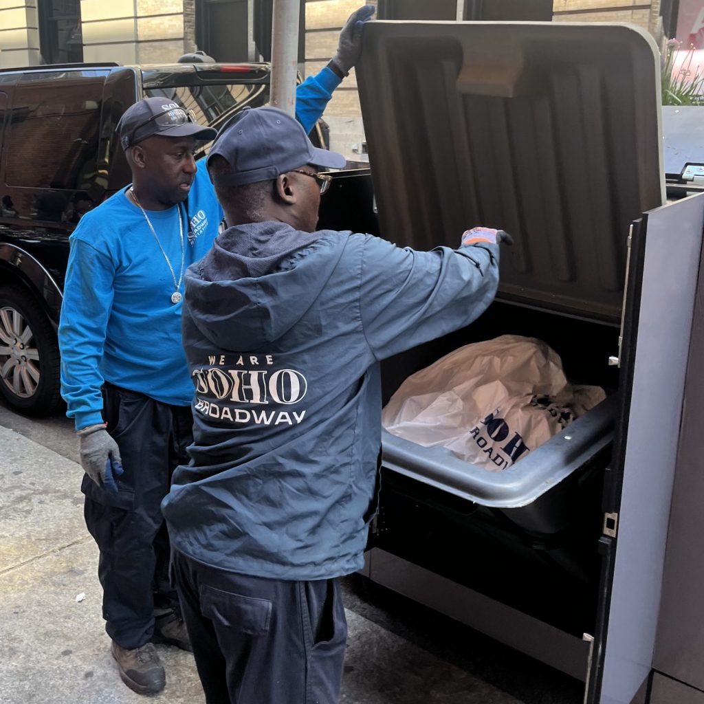 SoHo Broadway Clean Team Field Supervisors loading the bin box waste container