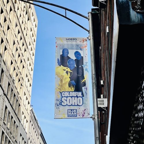 Streetlight banner featuring Blue Man Group