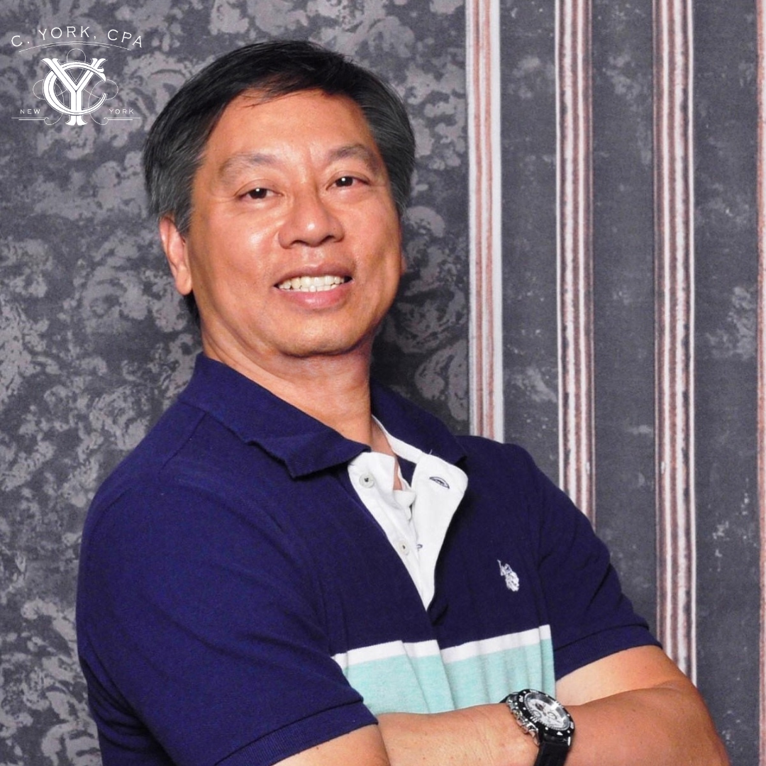 A professional headshot of a smiling man in a blue polo.