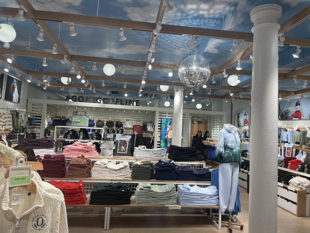 Stacks of folded clothes and a disco ball 