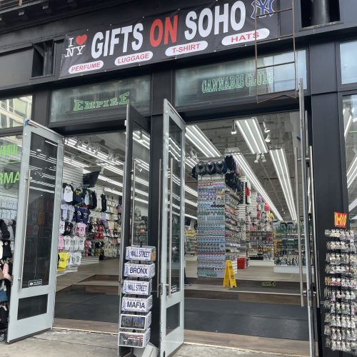 A souvenir shop with open doors and abundant merchandise.