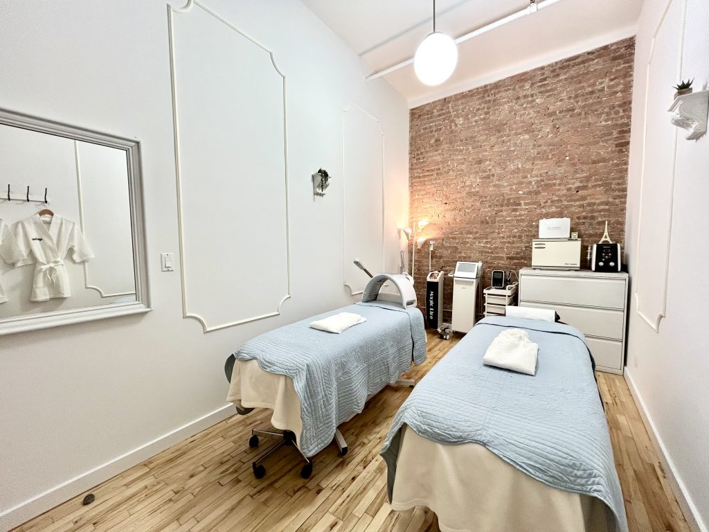 two spa beds in a room with exposed brick